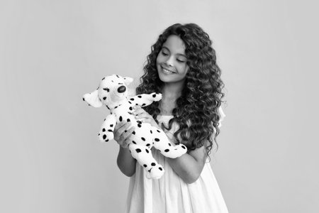 Funny teenage child hold toy. Happy childhood. Kid playing toy. Childcare concept. Happy teenager, positive and smiling emotions of teen girl.の写真素材