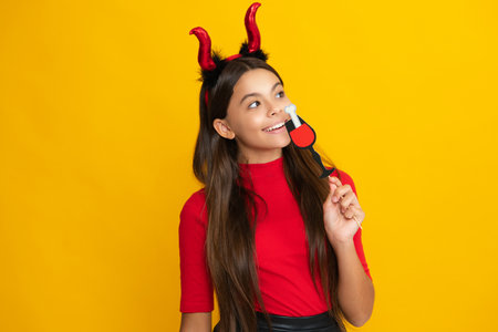 Teen girl with pumpkin. Halloween witch girl. Teen witch. Kid girl witch celebrates Halloween. Happy Halloween. Portrait of an Halloween child teenager girl. Seasonal autumn sale.の写真素材
