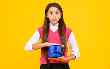Teenager girl hold gift box. Child holding gift box in Christmas or birthday. Girl with giftbox for...