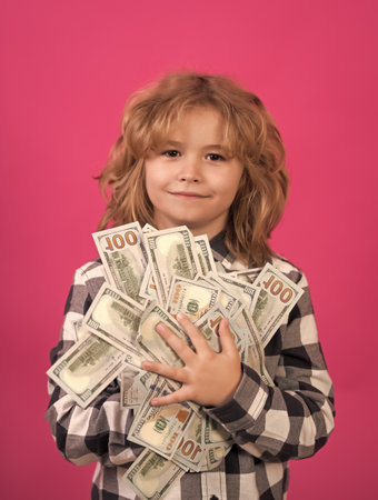Kid having a lot of hundred dollars isolated on pink red background.の写真素材