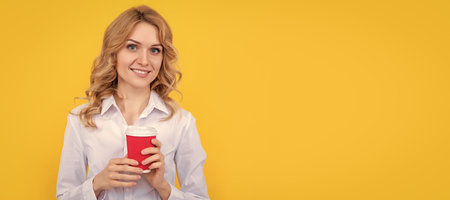 happy blond woman with coffee cup on yellow background. Woman isolated face portrait, banner with mock up copy space.の写真素材