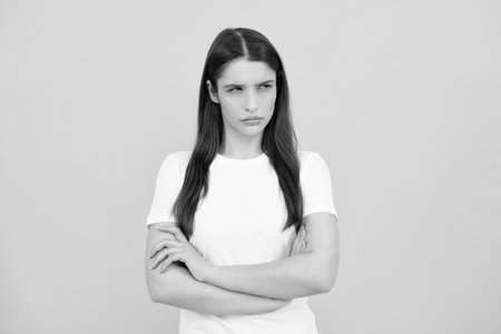 Portrait of young woman thinking, looking up empty space. Thoughtful serious model in studio looking away. Girl thought choose decide solve problems.の写真素材