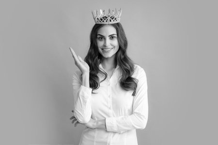 Young woman queen wear golden crown, isolated gray background.の写真素材