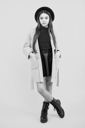 Full length of attractive cheerful teenager child girl in casual fashion clothes over yellow isolated background.の写真素材