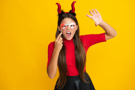 Halloween witch girl. Teen girl with pumpkin. Teen witch. Kid girl witch celebrates Halloween. Happy Halloween. Portrait of an Halloween child teenager girl. Seasonal autumn sale.の写真素材