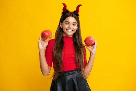 Child teen girl having fun on Halloween. Funny little girl with pumpkin. Halloween witch girl. Cute teen witch. Happy Halloween. Portrait of an Halloween child.の写真素材