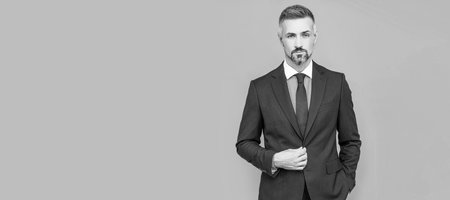 charismatic businessman man in businesslike suit, charisma. Man face portrait, banner with copy space.の写真素材