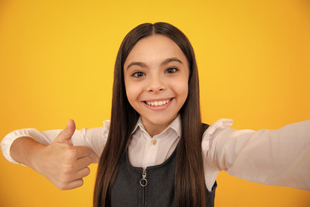 Funny stylish young hippie teen girl making selfie. Happy teenager, positive and smiling emotions of...