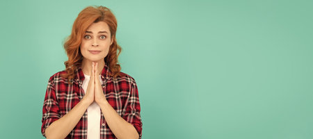 Woman isolated face portrait, banner with mock up copyspace. praying redhead woman in checkered...
