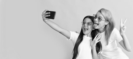 Mother and daughter child banner, copy space, isolated background. funny mom and kid making selfie...