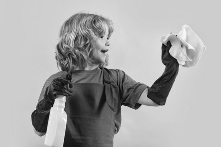 Child cleans at home concept. Kid cleaning to help with housework. Little cute boy cleaning,...