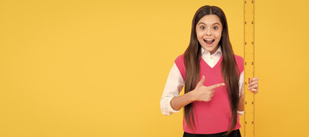 feeling of surprise. concept of education. measuring and sizing. height of child. Banner of school girl student. Schoolgirl pupil portrait with copy space.の写真素材