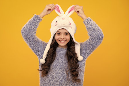 Fun bunny warm hat. Winter hat. Cold season concept. Winter fashion accessory for children. Teen...