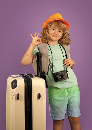 Kid on travel, isolated studio portrait. Child travel and adventure concept.の写真素材