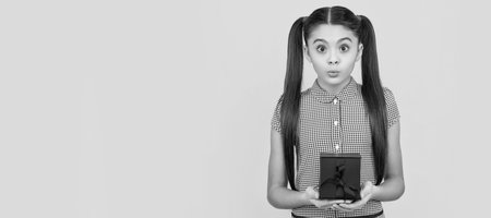 Teenager birthday. present for womens day. teen girl holding giftbox. child prepare for holidays. Kid girl with gift, horizontal poster. Banner header with copy space.の写真素材