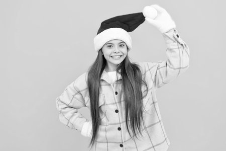 winter fashion. happy new year. merry christmas. glad kid in santa claus hat.の写真素材