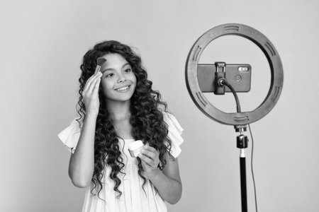 Teenager recording online media video. Teen girl streaming online and sharing social media content...