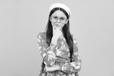 Thoughtful teenager child thinking, pensive child making idea. Kid curious creative think about creating plan. Serious teenager girl.の写真素材