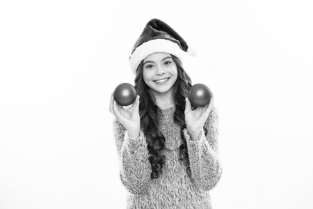 Winter teen girl hold christmas balls. Merry christmas. Studio portrait of christmas teenager girl on white isolated background.の写真素材