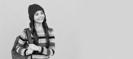 happy hipster teen girl with backpack going to school, back to school. Banner of school girl student. Schoolgirl pupil portrait with copy space.の写真素材