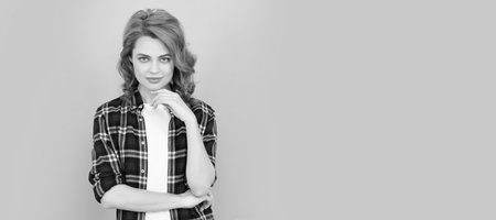 young redhead woman in checkered shirt on blue background. Woman isolated face portrait, banner with mock up copyspace.の写真素材