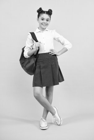 School and education concept. Back to school. Schoolchild, teenage student with backpack, isolated, copy space. Happy teenager, positive and smiling emotions of teen girl.の写真素材