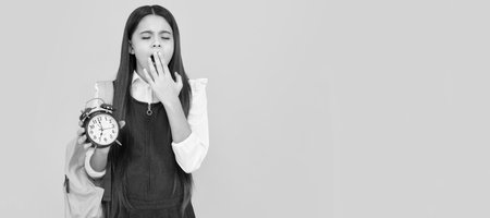 Back to school. Teenager schoolgirl with bag hold clock alarm, time to learn. Banner of school girl student. Schoolgirl pupil portrait with copy space.の写真素材