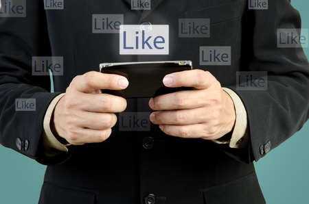 Businessman touch smart phone in hand with like social network