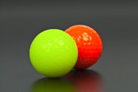 Green and orange golf ball