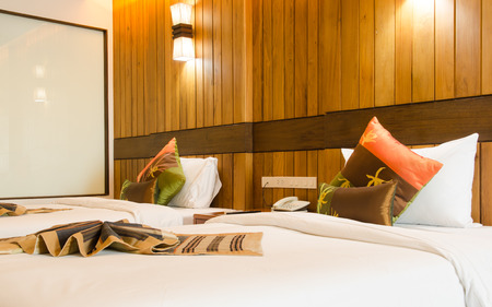 Bed in a hotel room at nightのeditorial素材