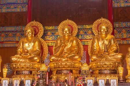 NONTHABURI THAILAND-JANUARY 24 : Three golden Buddhas seated at wat boromracha temple in nonthaburi.On JANUARY 24,2015 in Nonthaburi ,Thailand.のeditorial素材