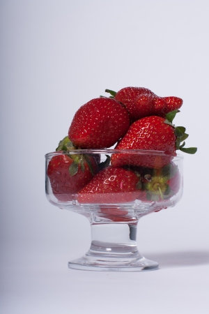 Strawberries in a bowl on a gray gradient background.の写真素材