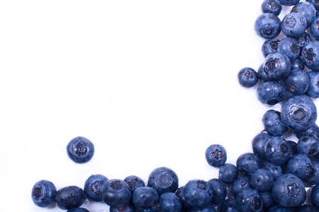 frame of ripe blueberries on a white background with water drops. space for text on the left.の写真素材
