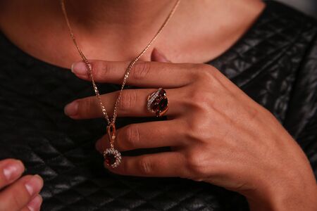 Gold jewelery in woman handの写真素材