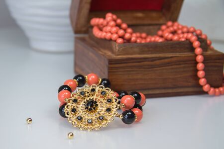 Stretch bracelet with coral and black Swarovski pearls and crystal filigre flower elementの写真素材