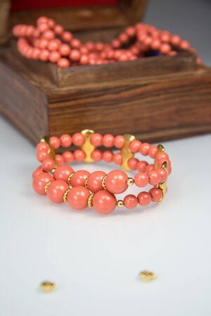 Coral beaded bracelet with pearlsa near jewelry boxの写真素材