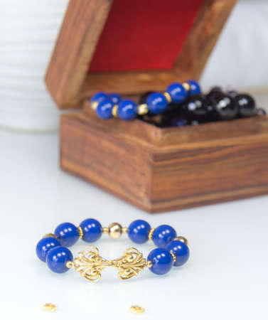 Blue beaded bracelet with pearls near jewelry boxの写真素材