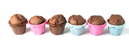 row of chocolate muffins isolated on white backgroundの写真素材