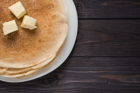 pancakes with butter on a wooden backgroundの写真素材