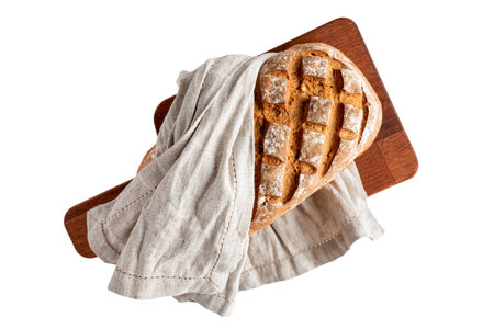 loaf of bread on cutting board directly above, isolated on a white background