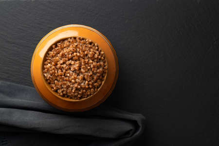 buckwheat porridge cooked in a clay pot in the oven, flat lay