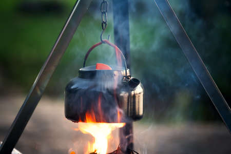 boiling water in a kettle while hiking