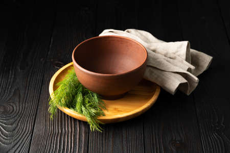 empty clay bowl on wooden backgroundの写真素材