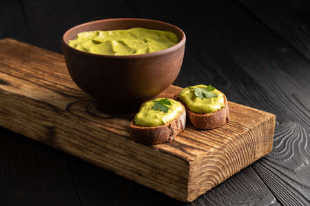 sandwiches with toasted bread and squash caviar with parsley on a wooden backgroundの写真素材