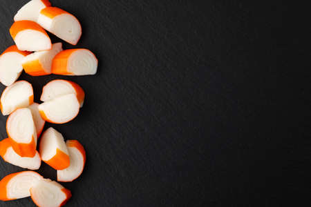 sliced crab meat on stone background, top view, place for textの写真素材