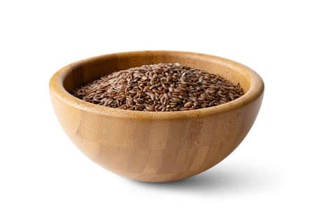 flax seeds in a wooden bowl on a isolated on a white backgroundの写真素材