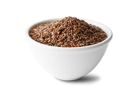 flax seeds in a ceramic bowl on a isolated on a white backgroundの写真素材