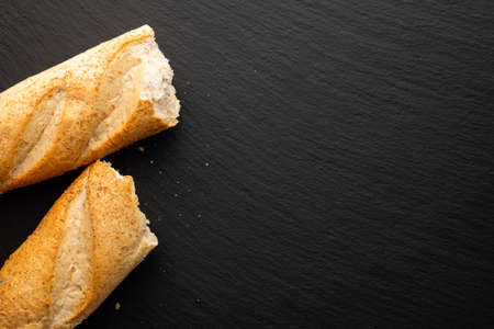 broken in half baguette on a stone background, top viewの写真素材