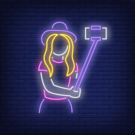 Lady taking selfie photo neon sign. Fashion, beauty and advertisement design. Night bright neon sign, colorful billboard, light banner. Vector illustration in neon style.のイラスト素材