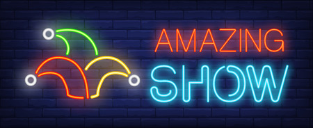 Amazing show neon text with jester hat. Circus performance advertisement design. Night bright neon sign, colorful billboard, light banner. Vector illustration in neon style.のイラスト素材
